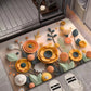 Floral diatom mud absorbent floor mat with teal leaves and circular orange blossoms