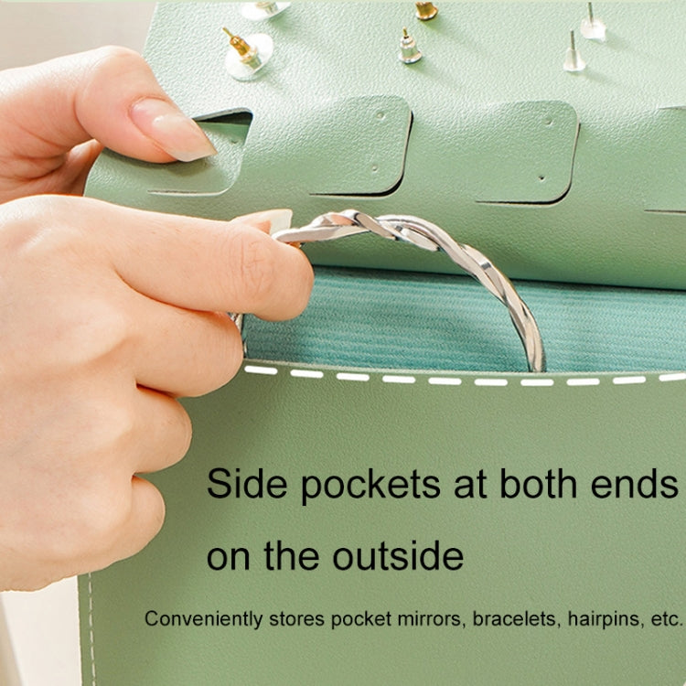 Green jewelry bag with side pocket flap and hand lifting strap, for added small items