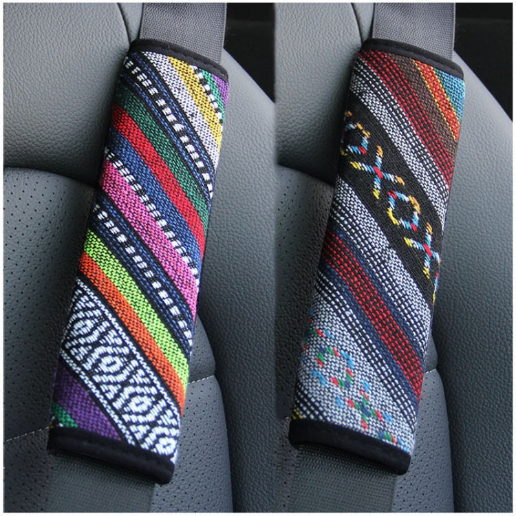Pair of car seat belt shoulder pads with colorful woven striped pattern on seats