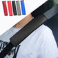 Dark gray seat belt shoulder pad cover with textured fabric, worn across chest