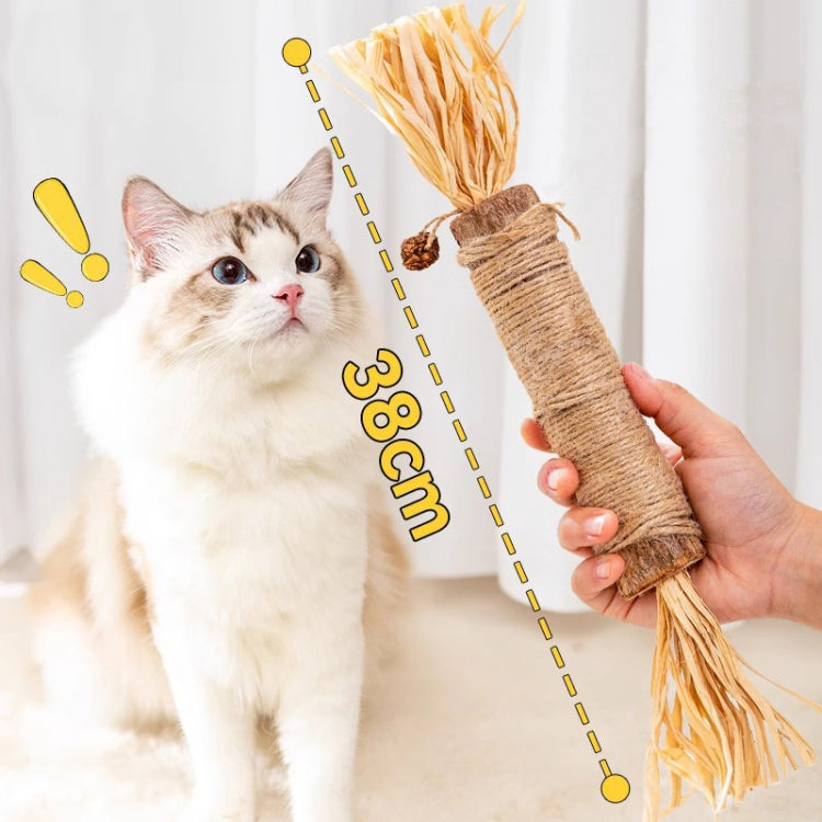 Silvervine cat dental toy, sisal-wrapped stick with raffia tassel, held near kitten