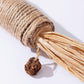 Close-up of sisal-wrapped silvervine toy stick with raffia tassels and brown seed ball
