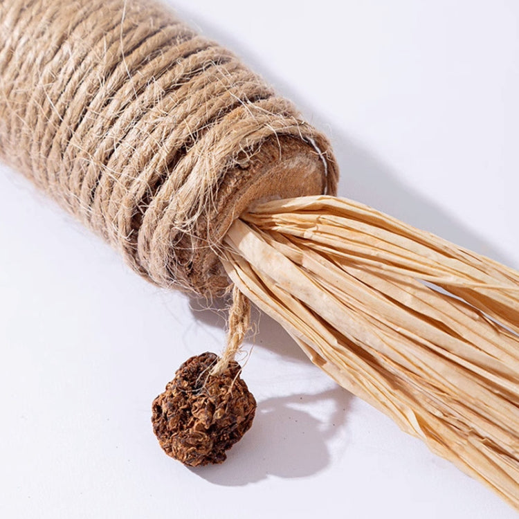 Close-up of sisal-wrapped silvervine toy stick with raffia tassels and brown seed ball