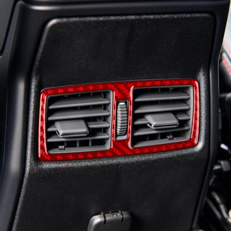 Dashboard rear air vent with red carbon-fiber trim sticker framing the louvers