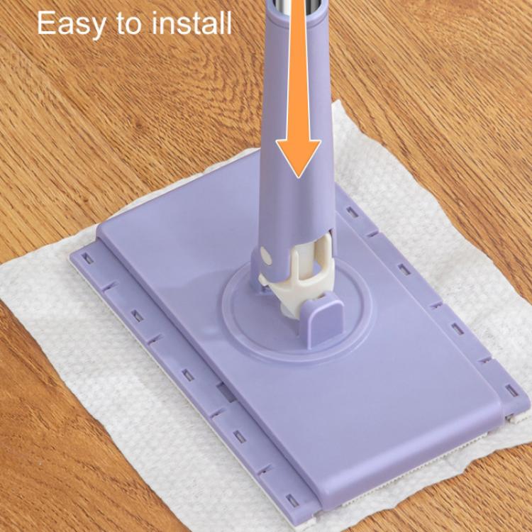 Automatic paper mop base spreading a white cloth pad on a wood floor