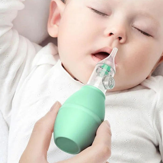 Baby nasal aspirator in use on a baby’s nose with clear suction tip