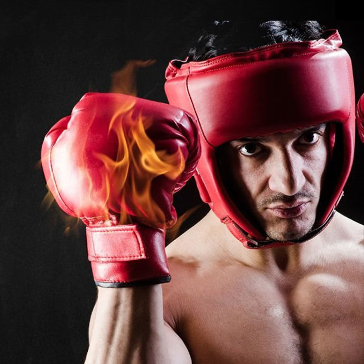 Red boxing sparring helmet with black face cage worn by an athlete