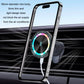 Dark gray wireless car phone holder with phone mounted and glowing charging ring