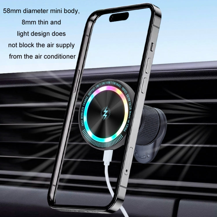 Dark gray wireless car phone holder with phone mounted and glowing charging ring