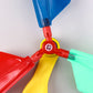 Close-up of balloon helicopter rotor connector in red with blue and green propeller blades