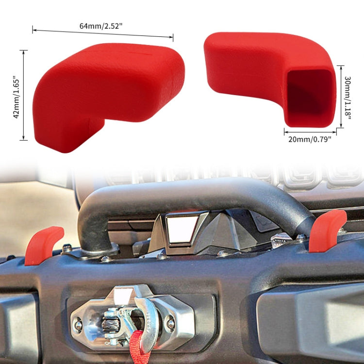Red two-piece trailer hook cover caps installed on a front bumper tow hook area.