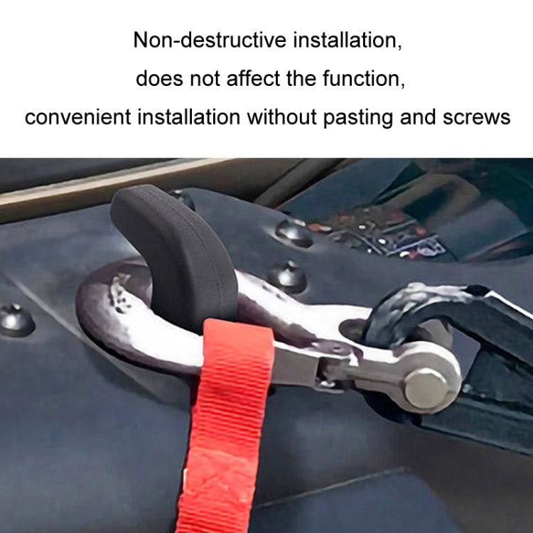 Red trailer hook cover cap fitted on front bumper tow point area.