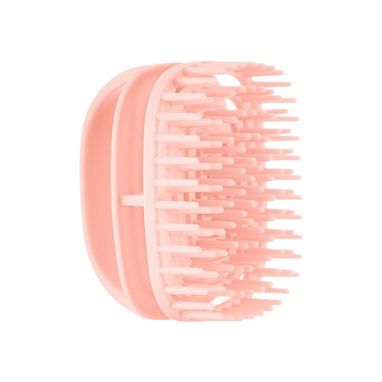 Pink silicone scalp shampoo brush with flexible massage teeth, handheld