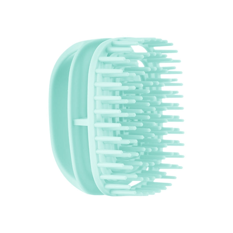 Mint green silicone scalp shampoo brush with soft massage teeth, handheld