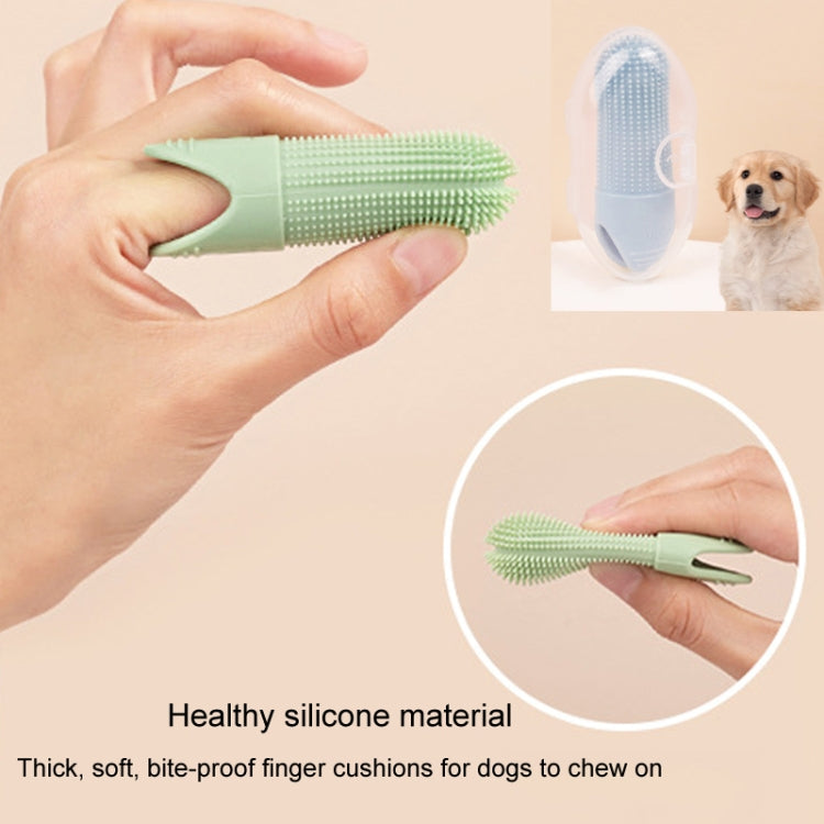 Green silicone pet finger toothbrush held in hands
