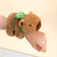 Brown plush turtle snap-ring bracelet with green frog-style backpack and pull ring