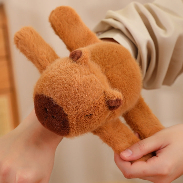 Orange plush dolphin snap-ring bracelet held in hand