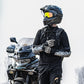 Motorcycle rider wearing white-and-gray knee and elbow pads with black straps and yellow accents