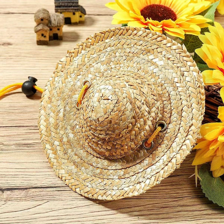 Tan woven straw pet sun hat with yellow tie and black adjustable clips