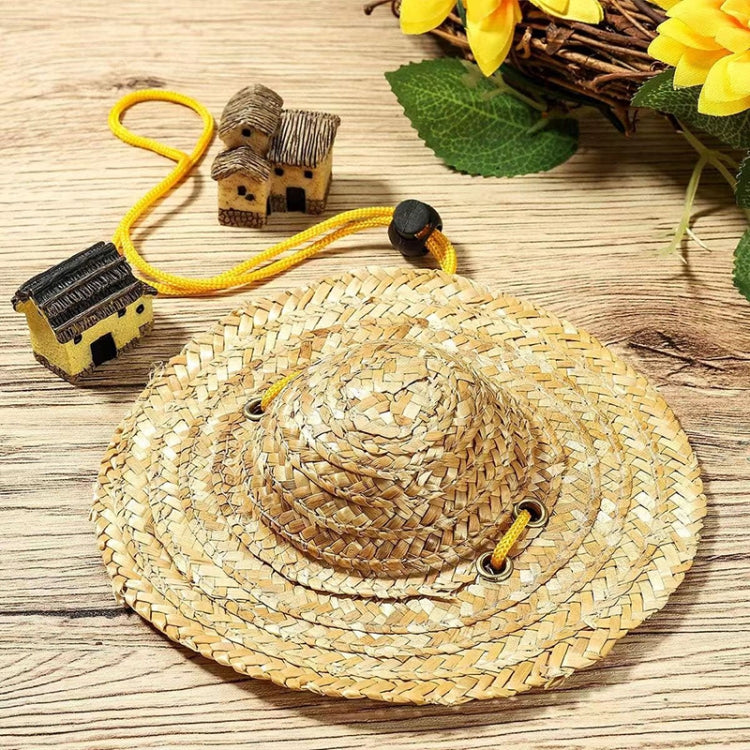 Tan woven straw pet sun hat with yellow strap and black adjustable clasp