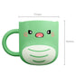 Green baby dinosaur brushing cup with rounded mouth and cartoon face