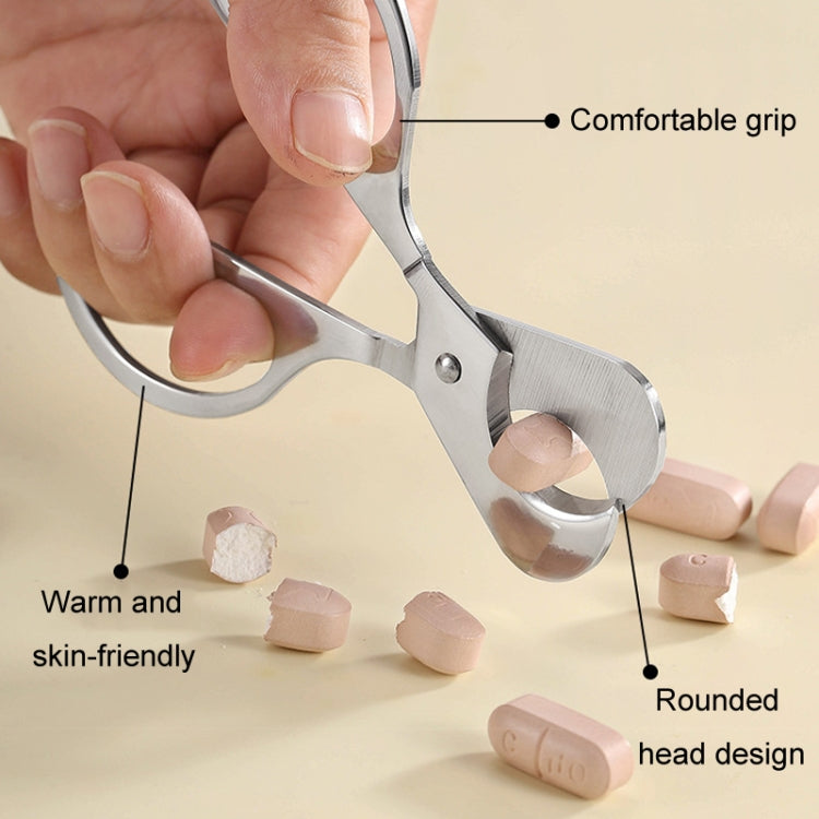 Stainless steel pill cutter with rounded head design and warm, skin-friendly silicone grip