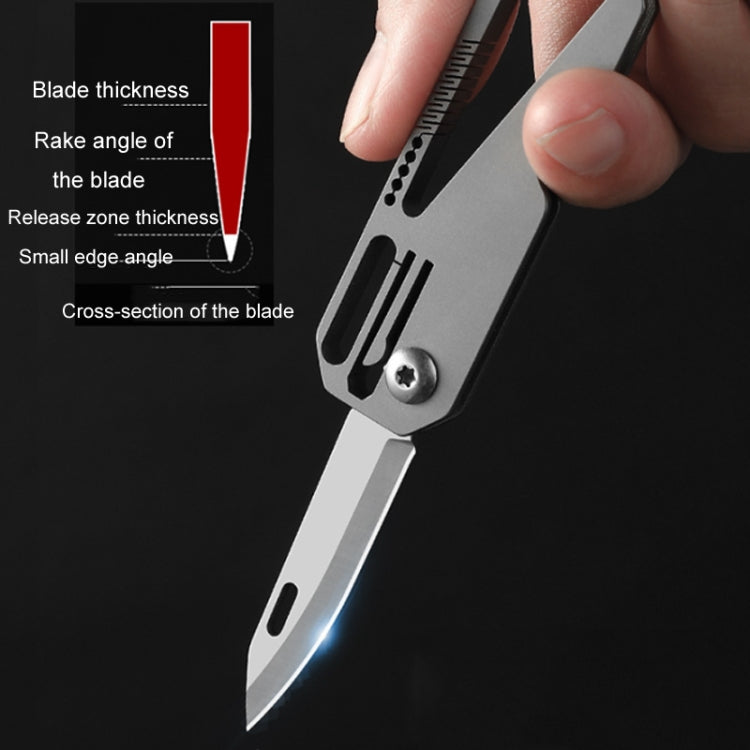 Close-up of folded mini knife blade with vent slots and rivet fastener