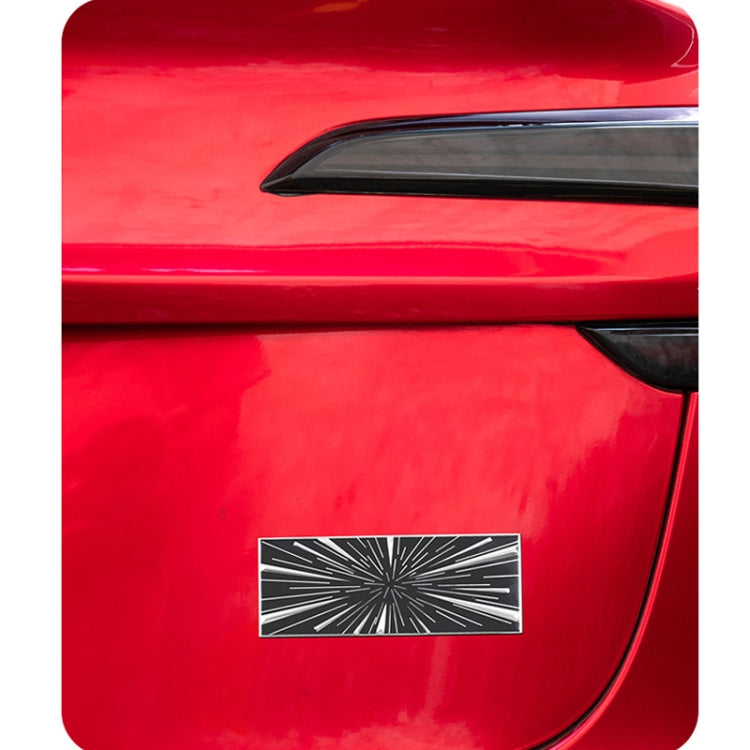 Metal car tail decoration label on red bumper, black-and-white time tunnel starburst