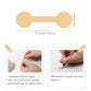 Hand applying tan jewelry tag sticker labels on paper surface