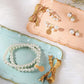 Tan jewelry tag sticker icons and pearl jewelry on a decorative tray