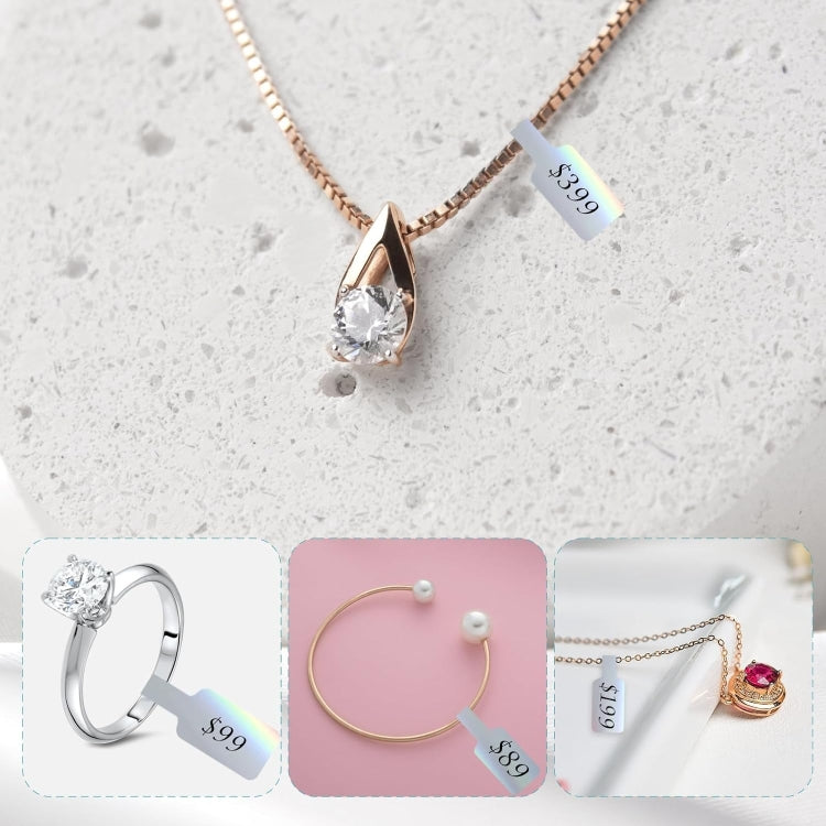 Rose-gold necklace and ring with jewelry price tags on light gray stone