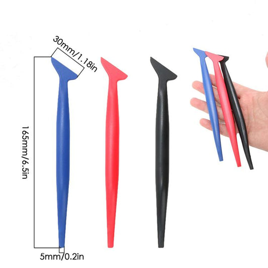 Three car film scrapers with long pointed wedge tips in blue, red, and black