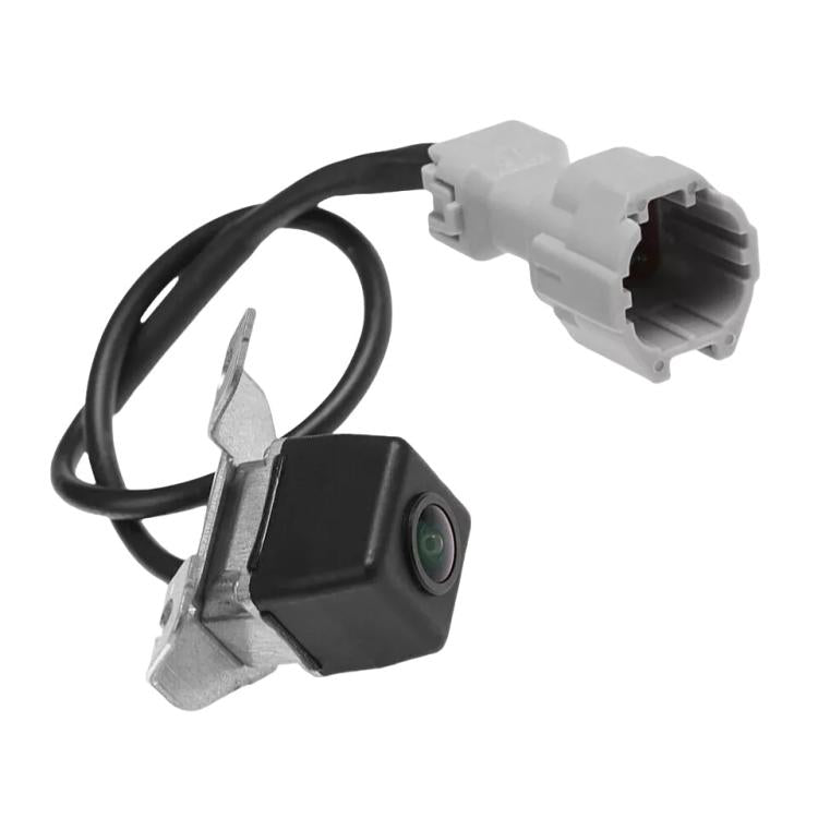 Black rear camera with green lens, bracket and white electrical connector on cable