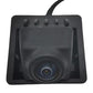 Black backup camera lens in square mounting housing