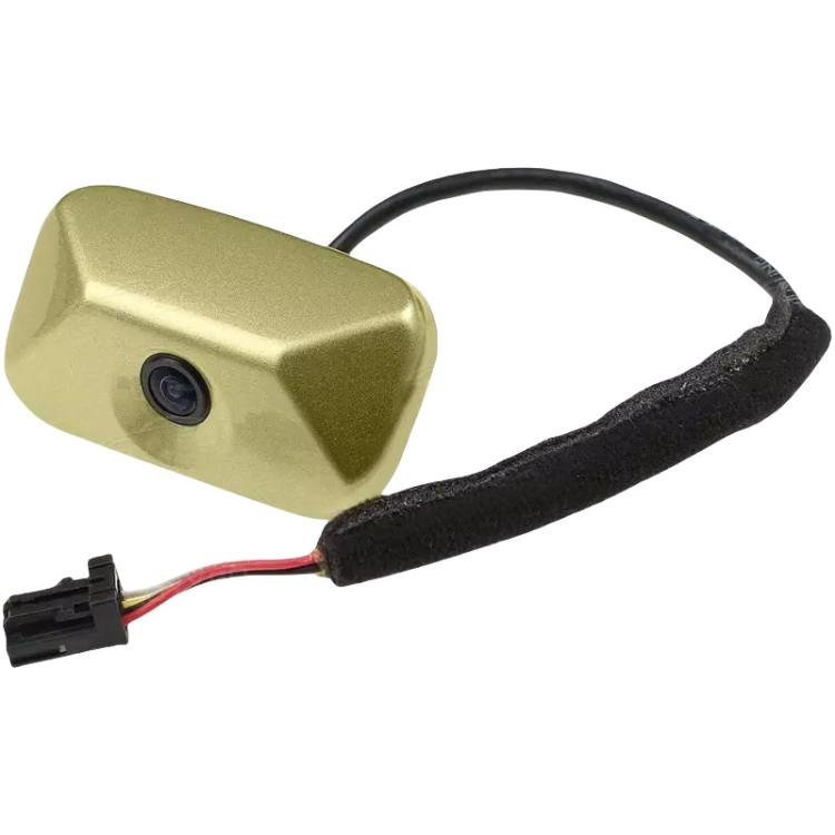 Reversing assist camera with gold housing and black cable, connector plug visible