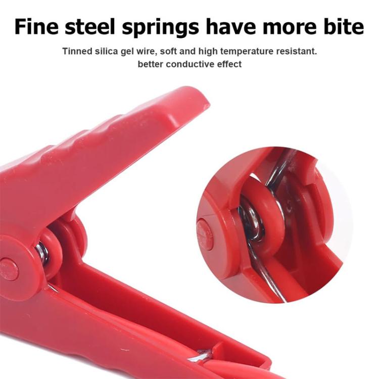 Close-up of red crocodile clamp with spring mechanism and metal contact