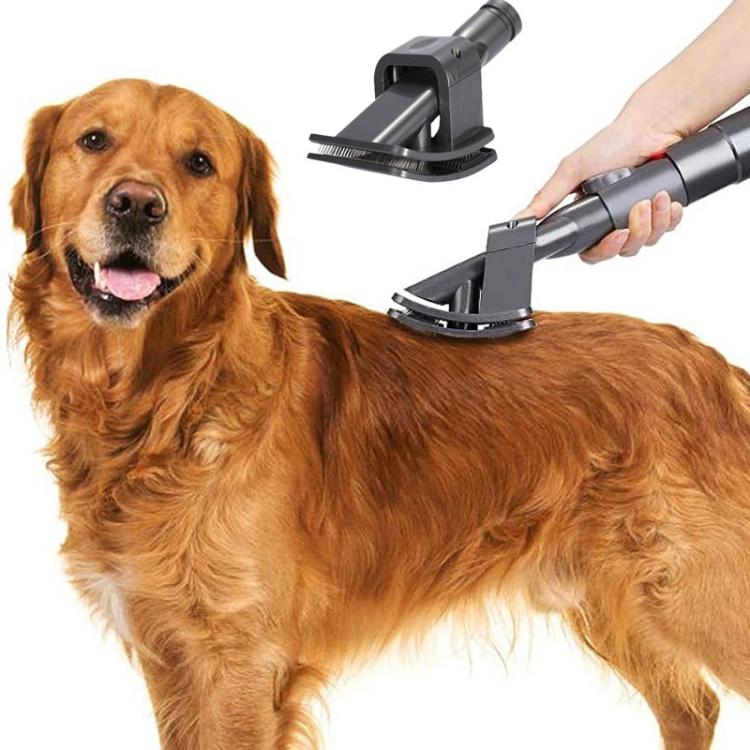 Vacuum pet hair brush attachment used on dog fur, shown with handle and bristles, dark gray