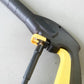 Yellow C-shaped sealing ring seated on a gray pressure washer coupling
