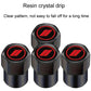 Close-up set of black tire valve caps with red oval logo on round top