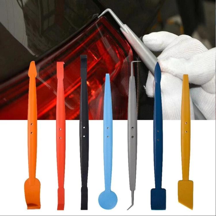 Car window tinting edge tools in multiple colors with gloved hand and scraper blades