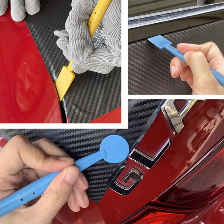 Hands applying car film with blue squeegee tool and trimming scraper edge tools