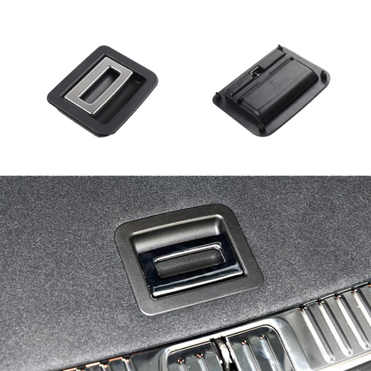 Black trunk puller with chrome insert; shown on car trunk mat