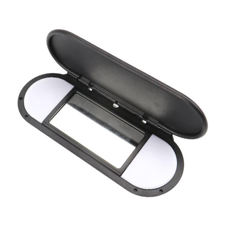 Black car sun visor vanity mirror, open lid showing rectangular mirror window