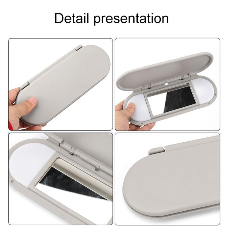 Gray car sun visor vanity mirror, close-up of open hinge and mirror frame