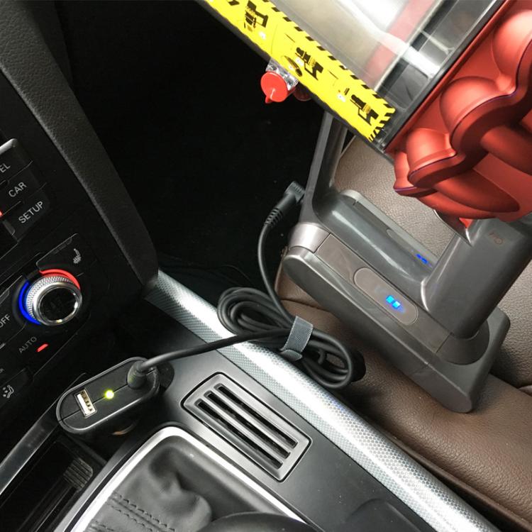 Car setup with charger connected to vacuum dock; charger cables visible