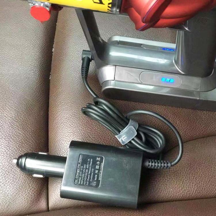 Black car charger adapter with barrel plug resting on seat, cable connected