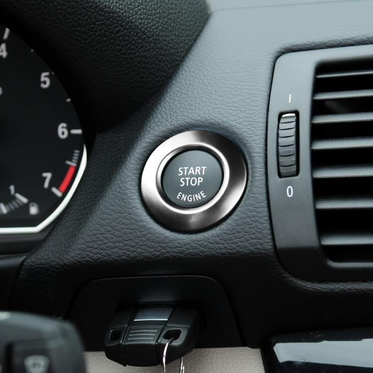 Silver start/stop button cover decoration ring on car interior dashboard