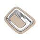 Beige car trunk inside puller switch with chrome surround and rectangular center pad.