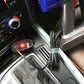 Car dashboard power socket with plugged-in Dyson vacuum charger and cable
