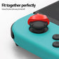 Teal controller grip with red silicone joystick cap on the analog stick